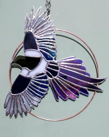 Stained glass Magpie in flight